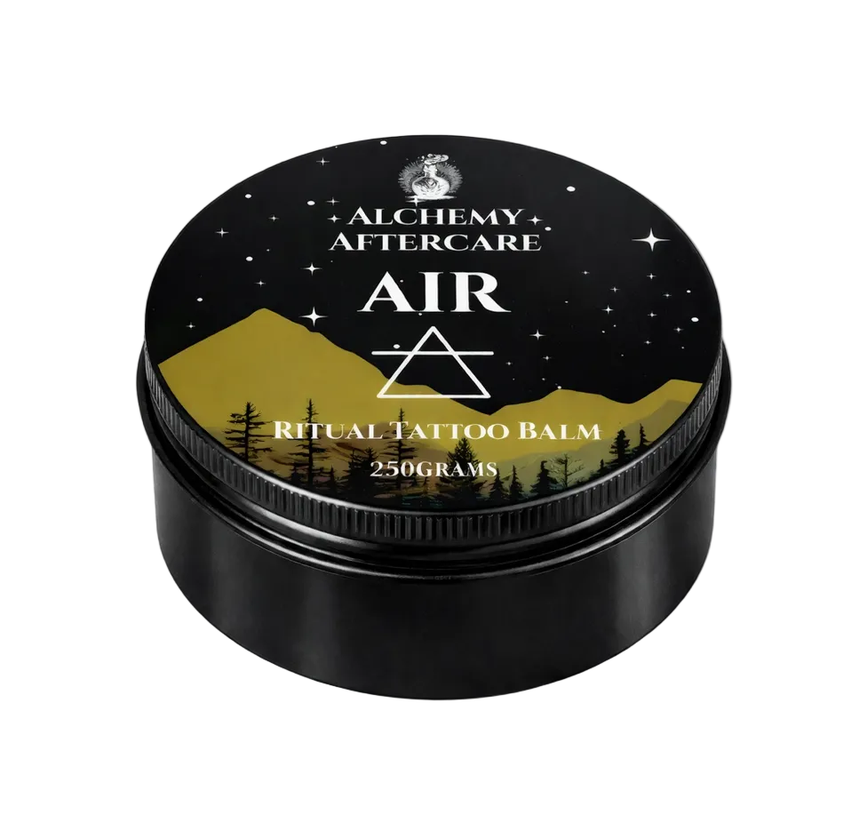 Black container of Alchemy Aftercare Air Ritual Tattoo Balm with mountain and star design on lid.