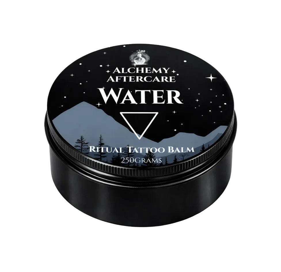 Black container of Alchemy Aftercare Ritual Tattoo Balm with mountain and star design on lid.